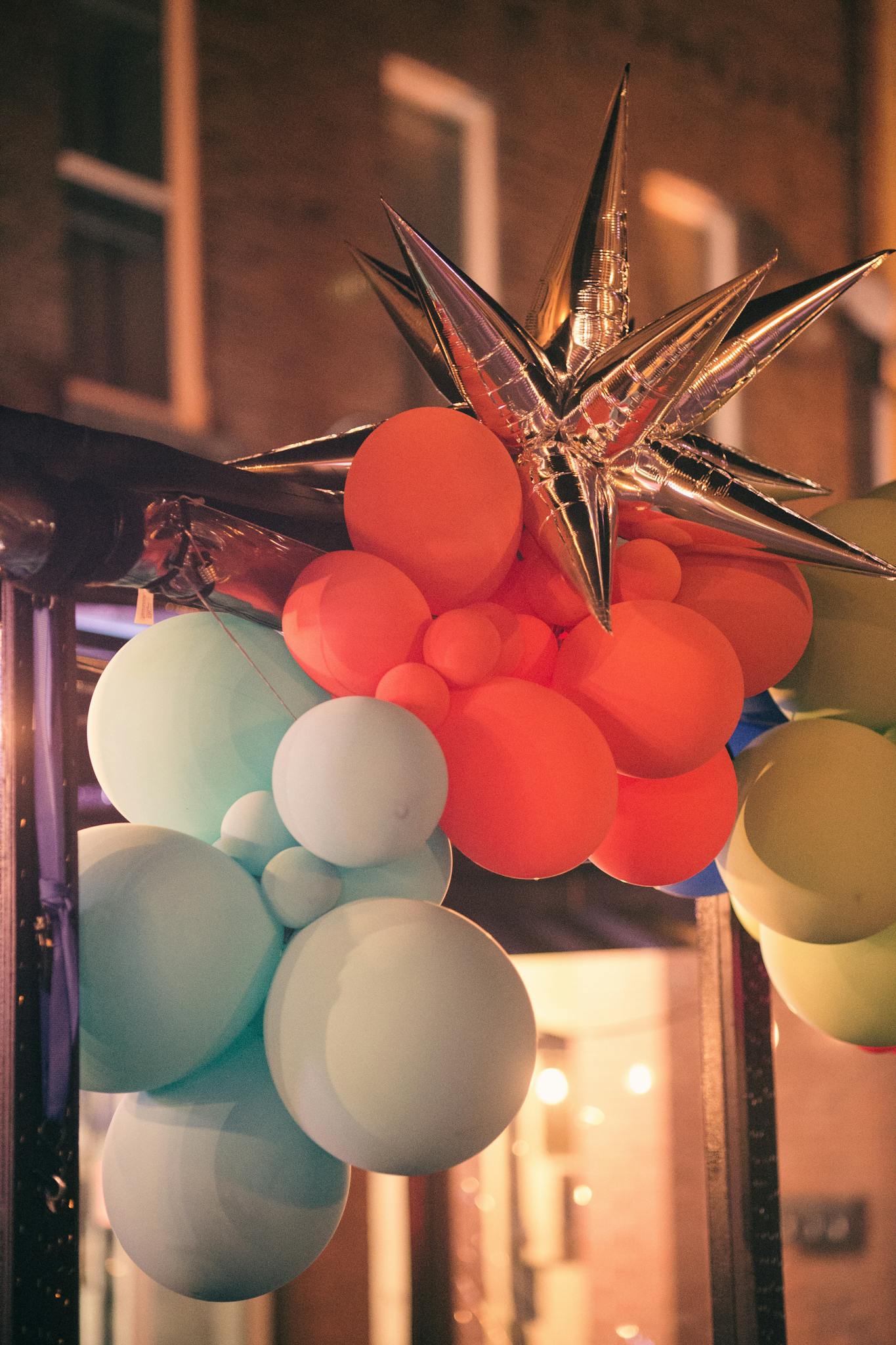 Colorful balloons and metallic star decoration creating a festive atmosphere, perfect for any celebration.