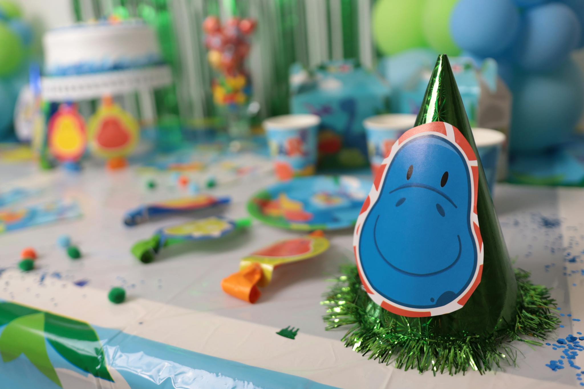 Vibrant dinosaur-themed birthday party decorations on a table setup for kids