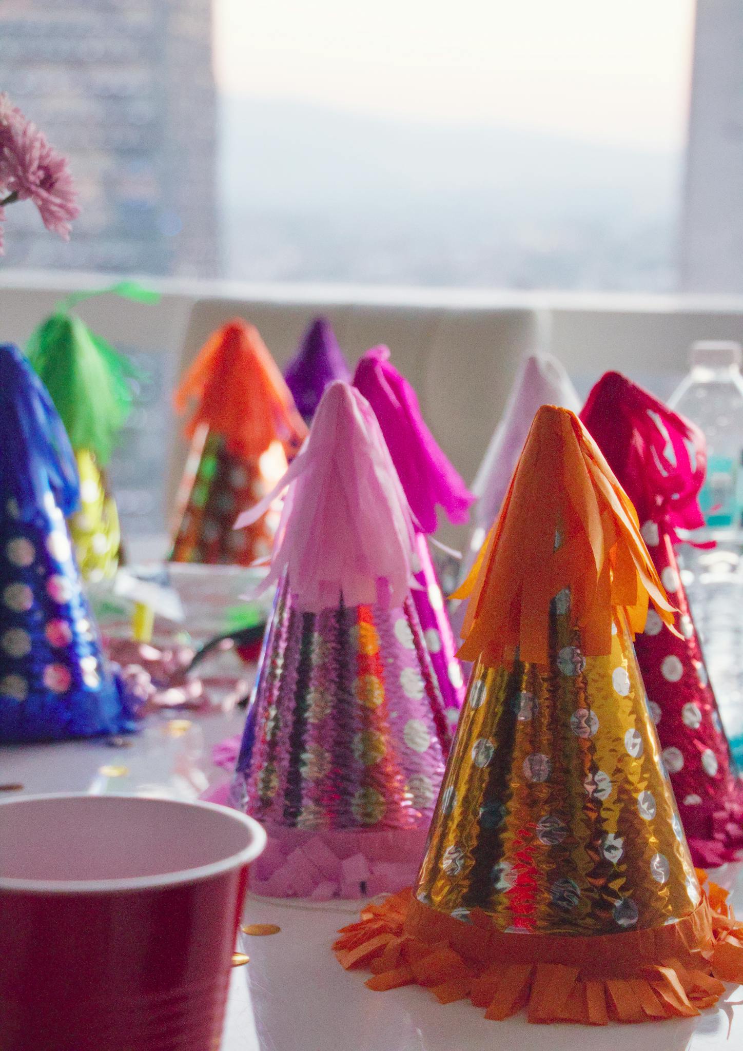 Vibrant party hats and decorations on a festive table setting indoors.